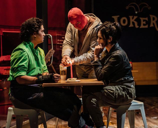 Jess Sayer (right) talks to Richard Te Are (left), while Simon Ferry lights a candle in Mr Red...