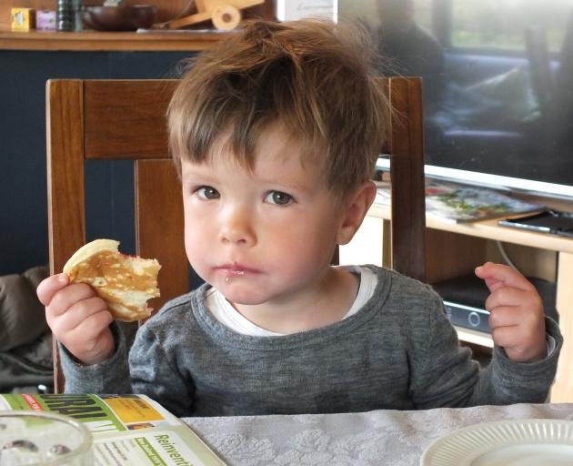 Ben Rutherford (2)  takes a break from gardening to sample a pikelet with Grandma’s homemade...