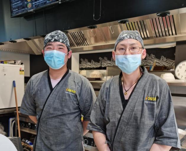 Huyeh Max and workmate Klein (left) say their iSushi bus interchange store has been targeted by...