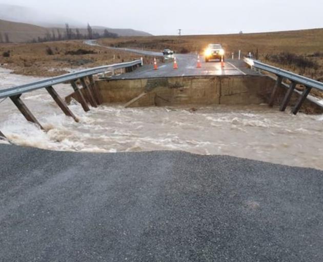 A bridge washed out on Lake Ōhau Rd near the SH8 turnoff on Tuesday. Photo: Supplied via RNZ /...