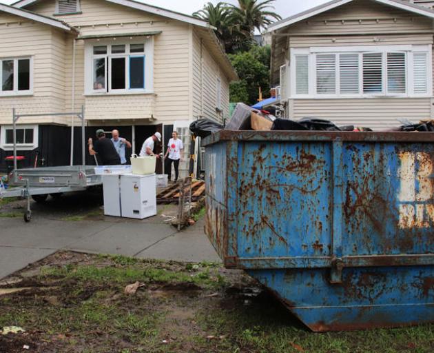 An Auckland family clear out a flood-damaged home. Photo: Getty Images