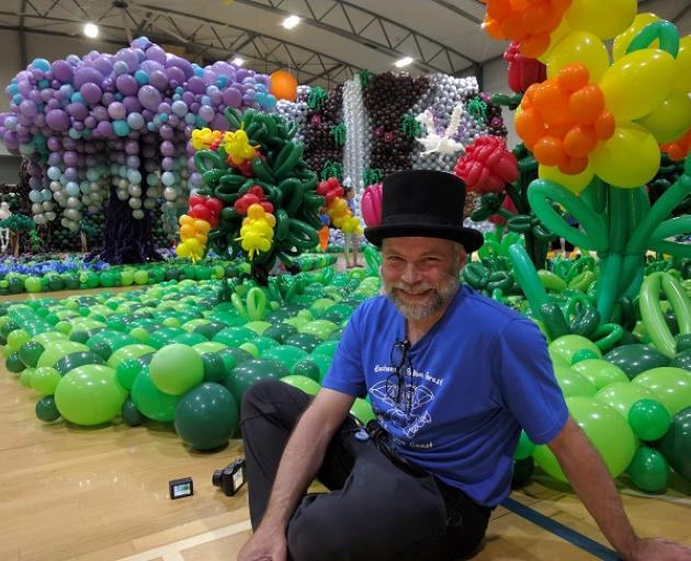 Jim Sheard with the enchanted forest created with balloons. 