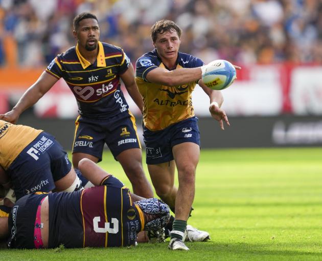 Force halfback Nathan Hastie fires out a pass in front of Highlanders opposite Folau Fakatava at...