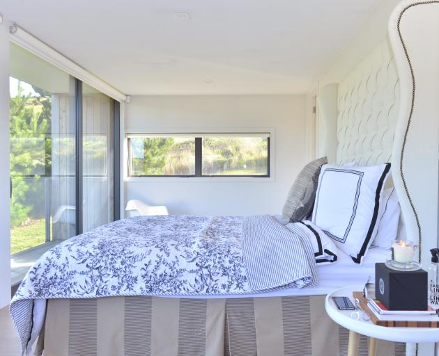 The main bedroom overlooks the St Clair golf course. The 2m-high upholstered bedhead was made by...