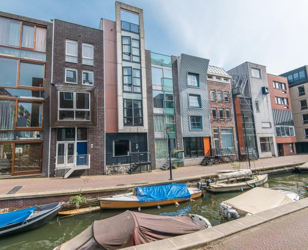 The typically narrow houses of Amsterdam overlook a canal in Java-eiland. Photo: Koen Smilde...