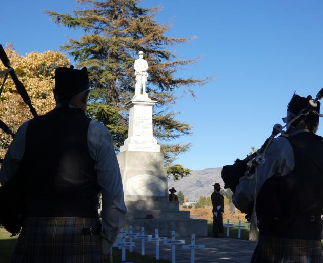 Bagpipers flank the Cromwell Cenotaph during Anzac Day commemorations. PHOTO: JARED MORGAN