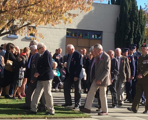 Anzac Day representatives form a procession during commemorations at the Cromwell cenotaph during...