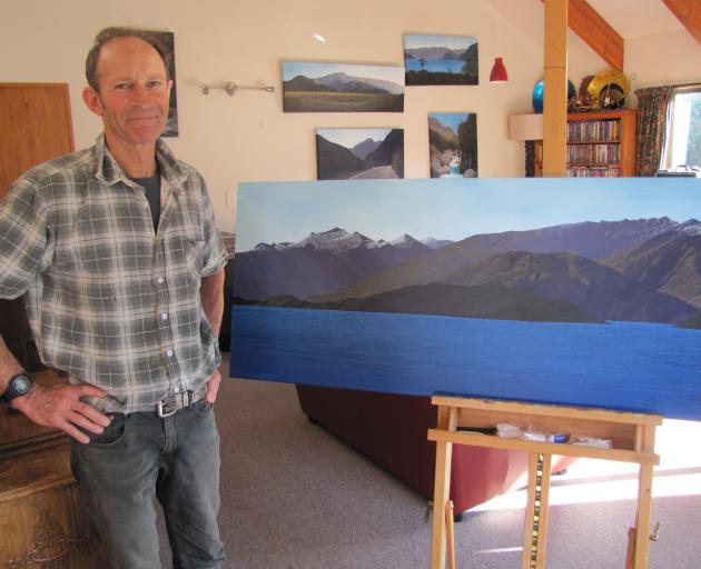 Richard Parsons looks over one of his paintings, of west Lake Wanaka. Photo: Pam Jones