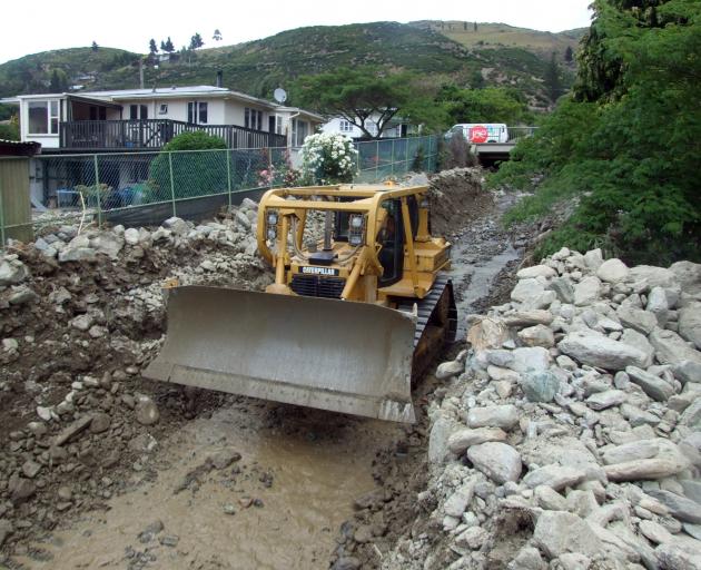 Bulldozers and excavators were being used by contractors in Reservoir Creek in the north end of Roxburgh yesterday afternoon to clear rocks from the area. Photo: Tom Kitchin