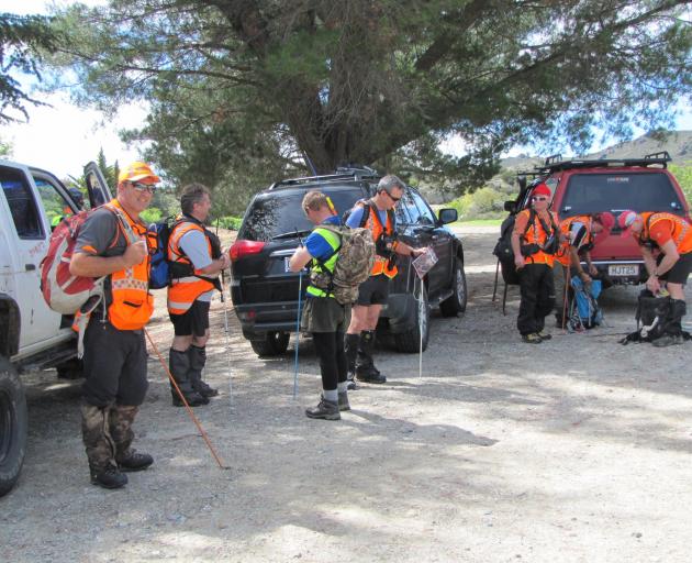 Land Search and Rescue volunteers prepare to search for a missing man in the Alexandra railroad...