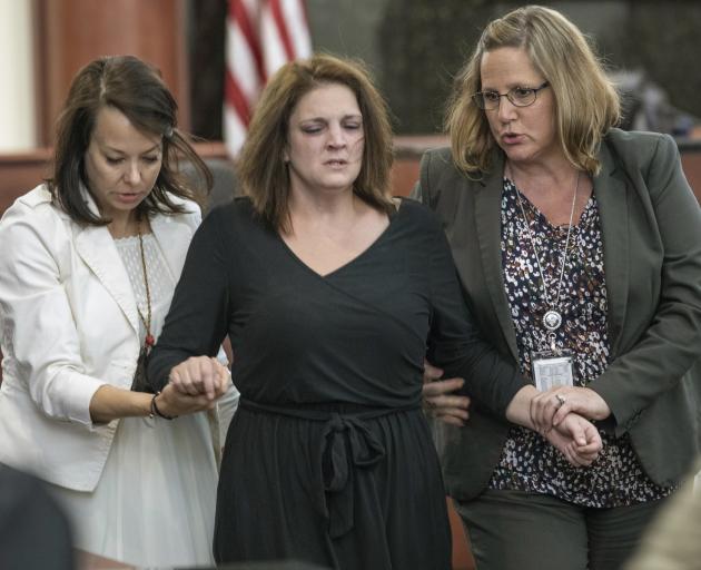 Amber Kyzer (centre) is helped out of the courtroom on Monday. Photo: The State via AP