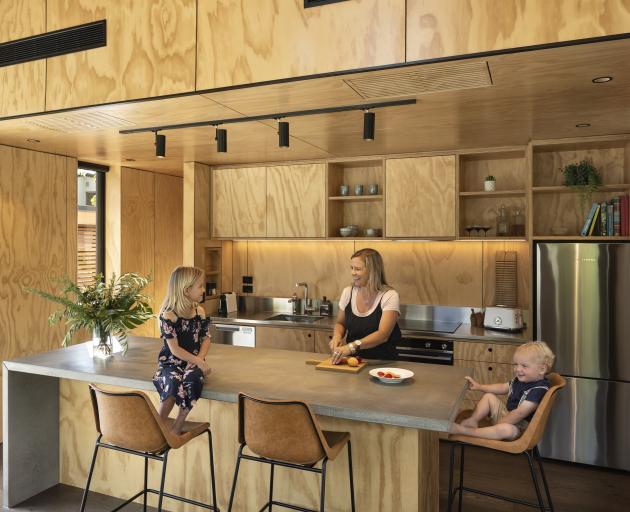 Materials in the house were limited to timber, black metal and concrete, with stone-look tiles...