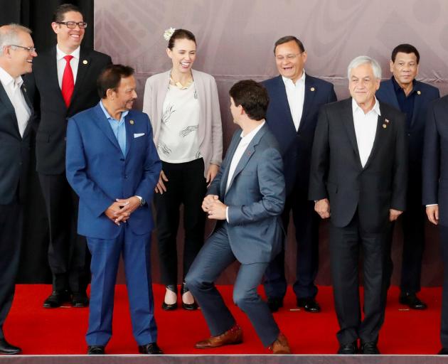Canada's Prime Minister Justin Trudeau (centre) shares a joke about his height with New Zealand's Prime Minister Jacinda Ardern on Sunday. Photo: Reuters 