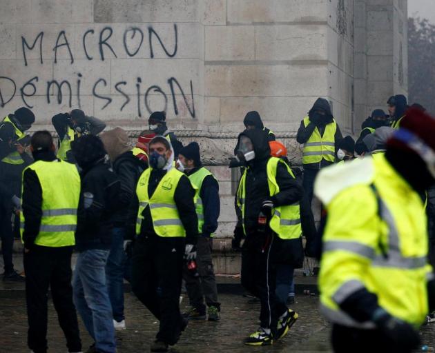 The words "Macron resign" were sprayed on the Arc de Triopmphe during protests at the weekend....