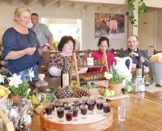 Jen Hussey (left) lights a birthday candle for Bilbo and Frodo Baggins with guests including...