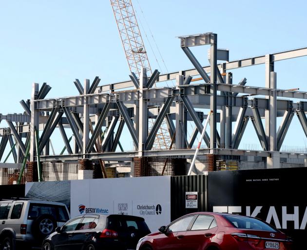 The framework of Te Kaha can now be seen rising above the site hordings. Photo: Geoff Sloan