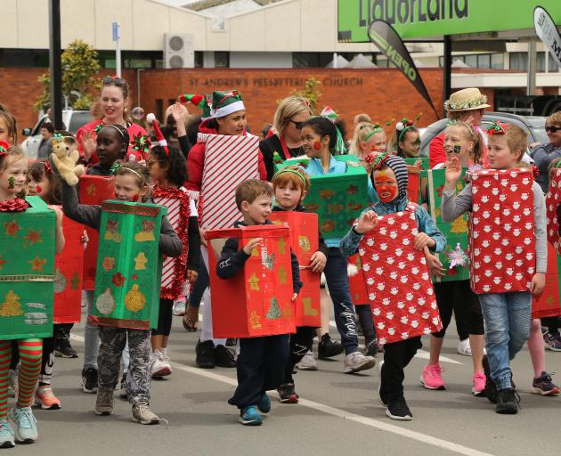 Children from Balclutha Primary school march as boxes and Christmas packages at the Clutha...