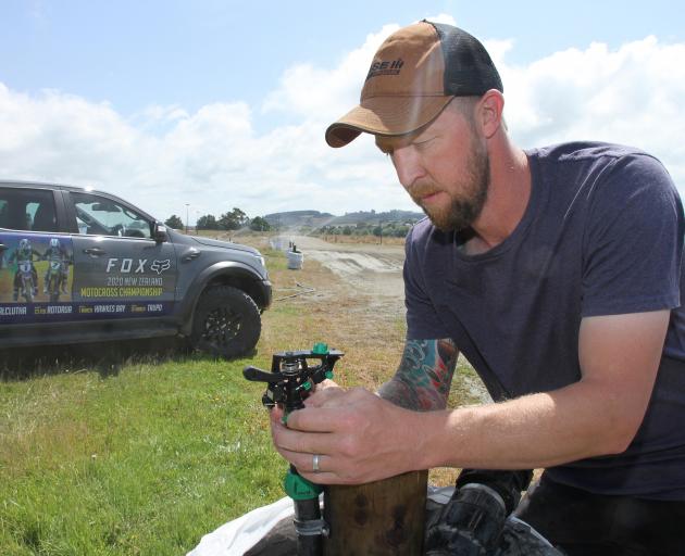 South Otago Motorcycle Club president Adam Robertson makes final adjustments to the dust...
