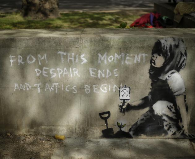 The painting on a wall appeared where a climate protest was held at London's Marble Arch. Photo: AP