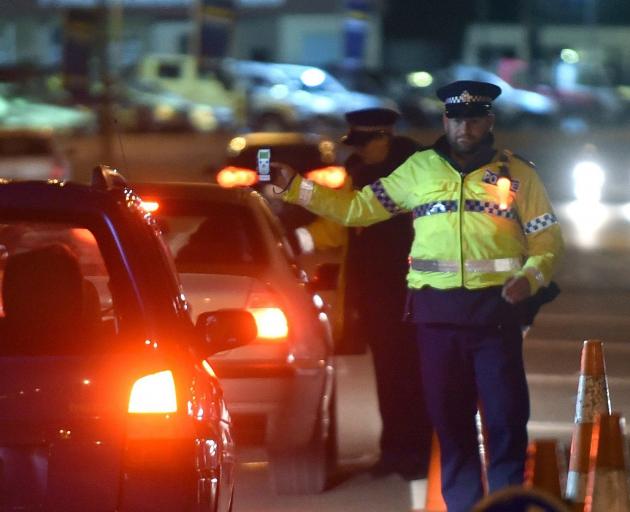 Police breath-test people at a checkpoint in Kaikorai Valley Rd in Dunedin. PHOTO: PETER MCINTOSH