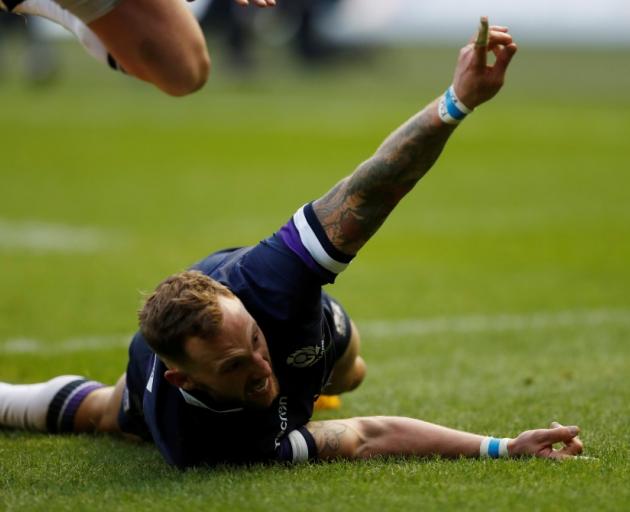 Scotland's Byron McGuigan celebrates scoring one of two tries in the match against Australia....