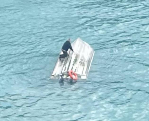 Photo from a helicopter circling the upturned vessel in Goose Bay with one person seen on the...