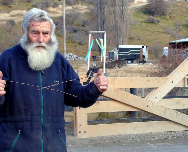 Ray Anderson believes divining rods point to graves under the car park at the entrance to...