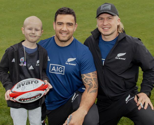 Mason Ratten, 8, with his heroes, All Blacks Codie Taylor and Jack Goodhue. Photo: Geoff Sloan