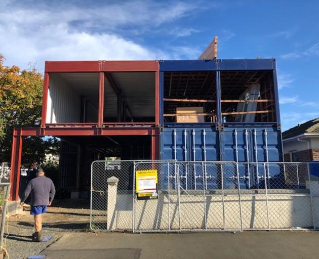 The front and back (below) of the property after the bare containers had been lifted into place....