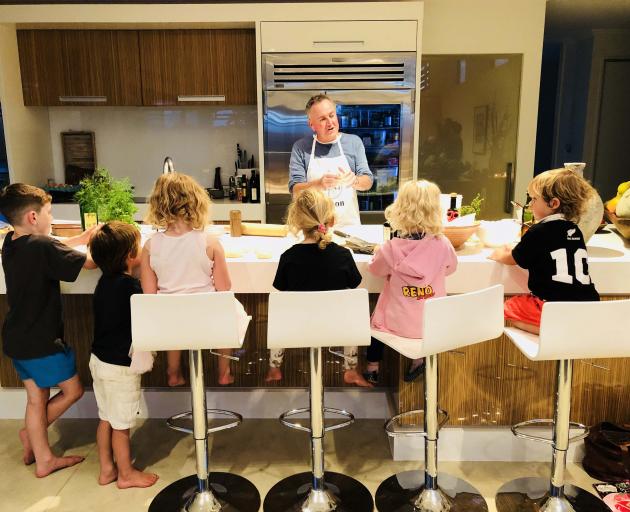 Simon Gault teaches a cooking to a group of daughter Hazel’s friends. Photo: Supplied