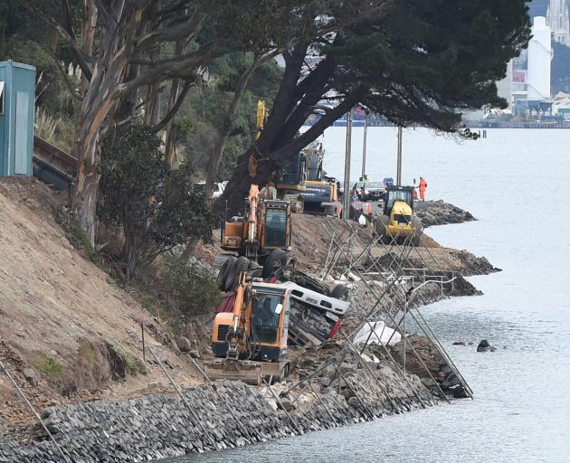 A truck lies on its roof after rolling down a bank on to the Otago Peninsula connection work site...