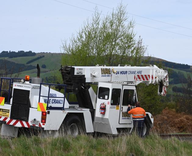 A crane was on site late this afternoon to help get the train back on track. Photo: Linda Robertson