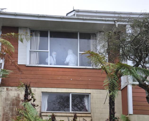 Police officers search the home of a Hokitika man charged with killing a 10-month-old baby. PHOTO...