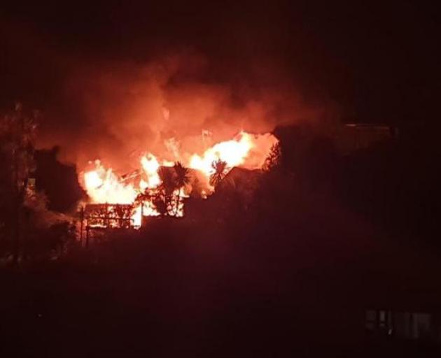 Castor Bay resident Lindsay Mouat took this photograph of the house ablaze in Taumatua. Photo:...