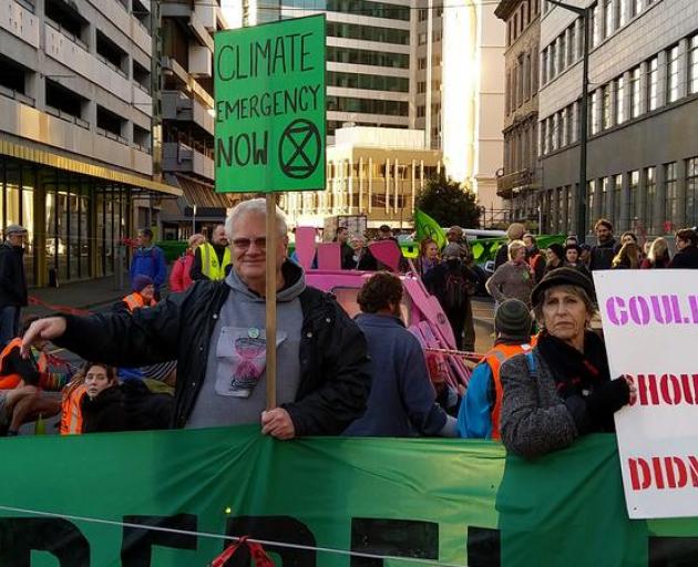 Extinction Rebellion protesters blocked off Stout St in central Wellington, in a bid to cause...