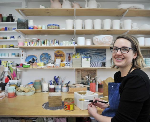 Elise Johnston works on one of her ‘‘boxes’’ in her home studio.