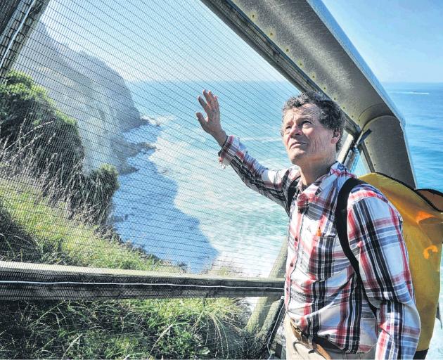 Graeme Loh and the fairy prion predator-proof fence above the St Clair cliffs. PHOTO: CHRISTINE O...