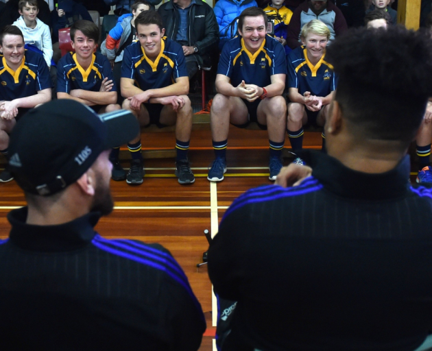 Members of the Taieri College under-15 rugby team put questions to All Blacks, including Aaron Cruden (L) and Ardie Savea, at the school gym last night. Photo Peter McIntosh