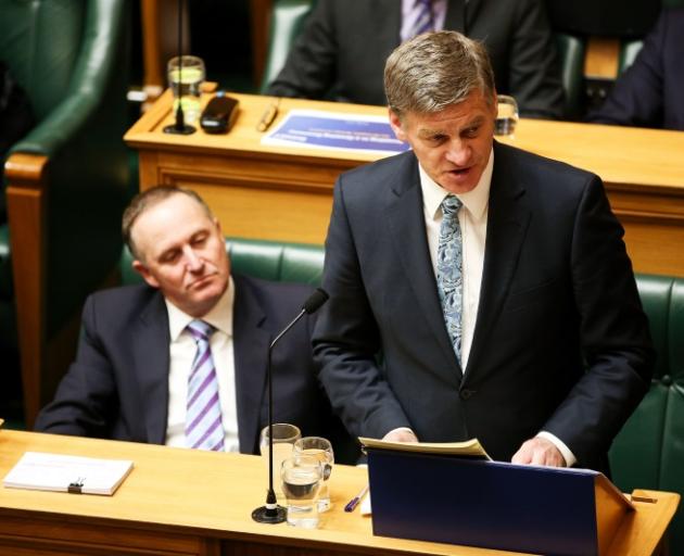 Finance Minister reads the Budget and Prime Minister John Key looks on at Parliament this afternoon. Photo by Getty