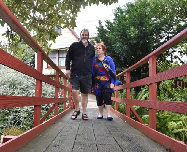 Bruce and Joy Hall’s plans are on hold after last year’s flood, which damaged their bridge, land and  garage, was followed by an insurance nightmare.  Photo by Gregor Richardson