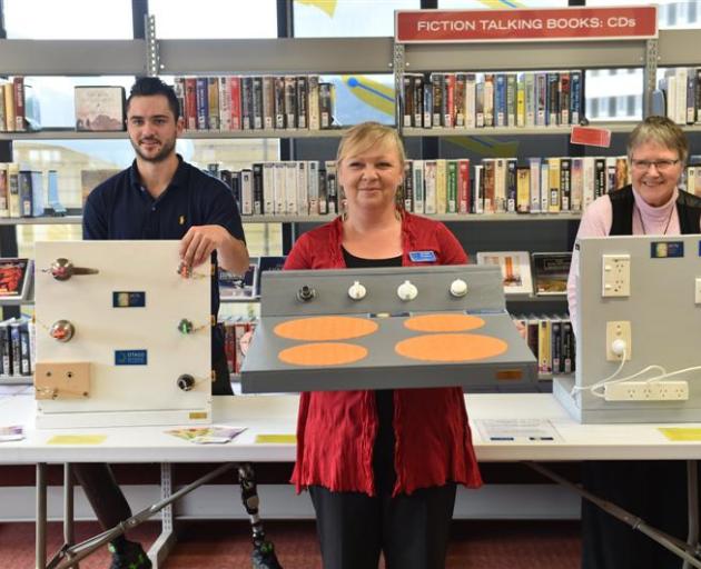 Holding activity boards, to help people with visual impairment, are Otago Polytechnic occupational therapy students Daniel Ajello and Nikki Donaldson, with Dr Lynley Hood (right), the founder of Victa. PHOTO: PETER MCINTOSH