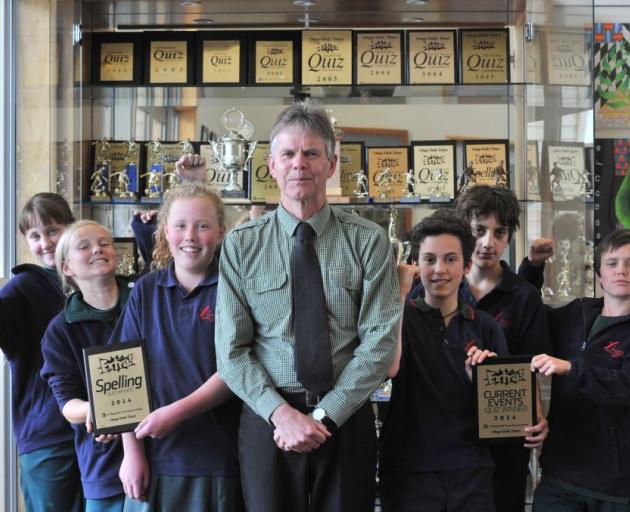 Tahuna Intermediate deputy principal Keith Hutton and pupils (from left) Emilia Haszard (13), Libby Hayday-Smith (12), Madeleine Gray (11), Kaya Reese (12), Oscar Te Morenga-Wakelin (12) and Ethan Smith (13) with some of the ODT Extra! quiz trophies they 