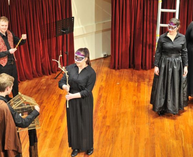 University of Otago music students (from left) Tyler Neumann (wearing cape), Sam Butter and Olivia Pike rehearse a Mozart Opera at Marama Hall. Photo by Linda Robertson.