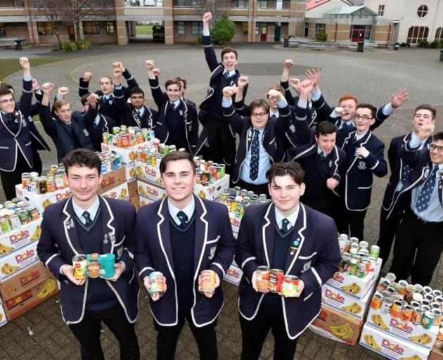 King's High School Octacan organisers Michael Freeman, James Beard and Paul Whiley (all 17) with members of the school's council and 2100 donated cans. PHOTO: GREGOR RICHARDSON