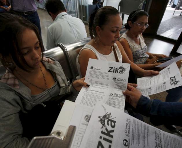 Information on preventing the Zika virus is given to women at a transport hub in Colombia. Photo: Reuters 