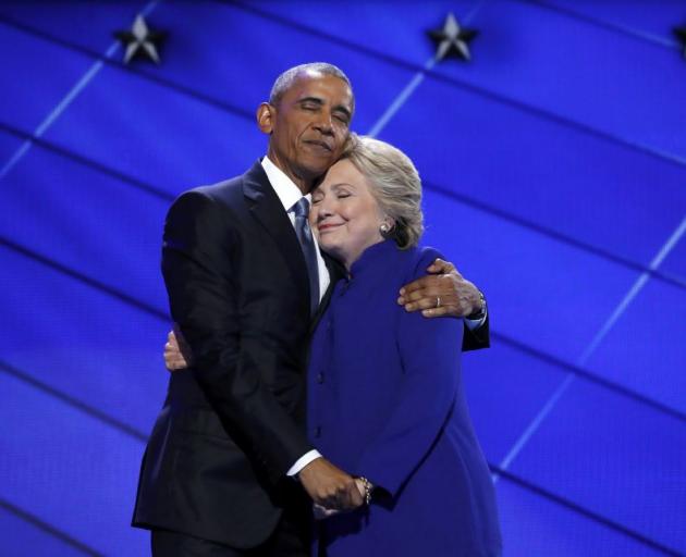 Hillary Clinton hugs President Barack Obama after his rousing speech in Philadelphia. Photo: Reuters 