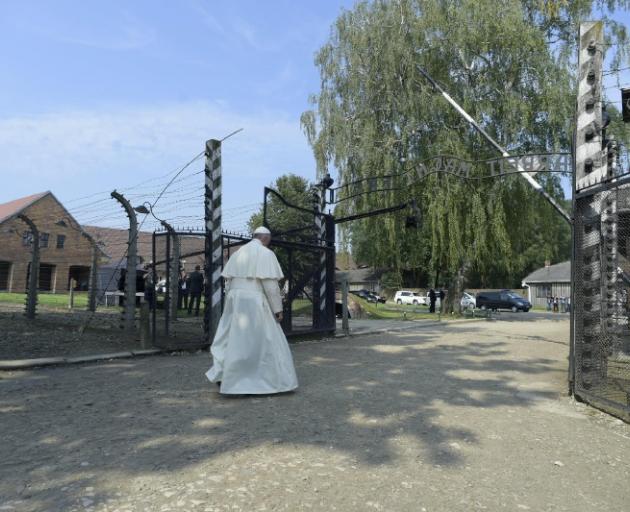 Pope Francis walks through a gate at the former concentration camp Auschwitz-Birkenau in Poland. Photo: Reuters  