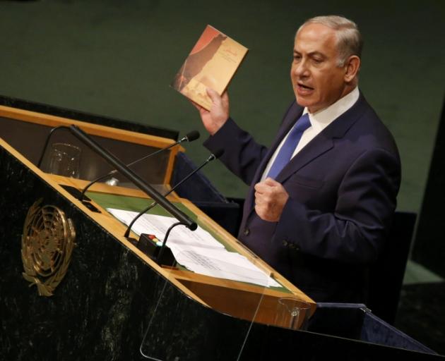 Benjamin Netanyahu with the latest book by Iranian Supreme Leader Ayatollah Ali Khamenei that he said was a "400-page screed detailing his plan to destroy the state of Israel."  Photo: Reuters