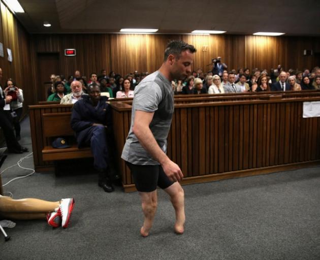 An emotional Oscar Pistorius removed his prosthetics and stood on his stumps for about five minutes in court. Photo: Reuters 