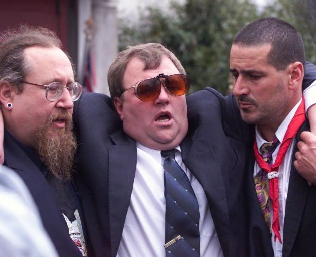 Mark Lundy being supported after the funeral of his wife Christine and daughter Amber in 2000. Photo: NZ Herald